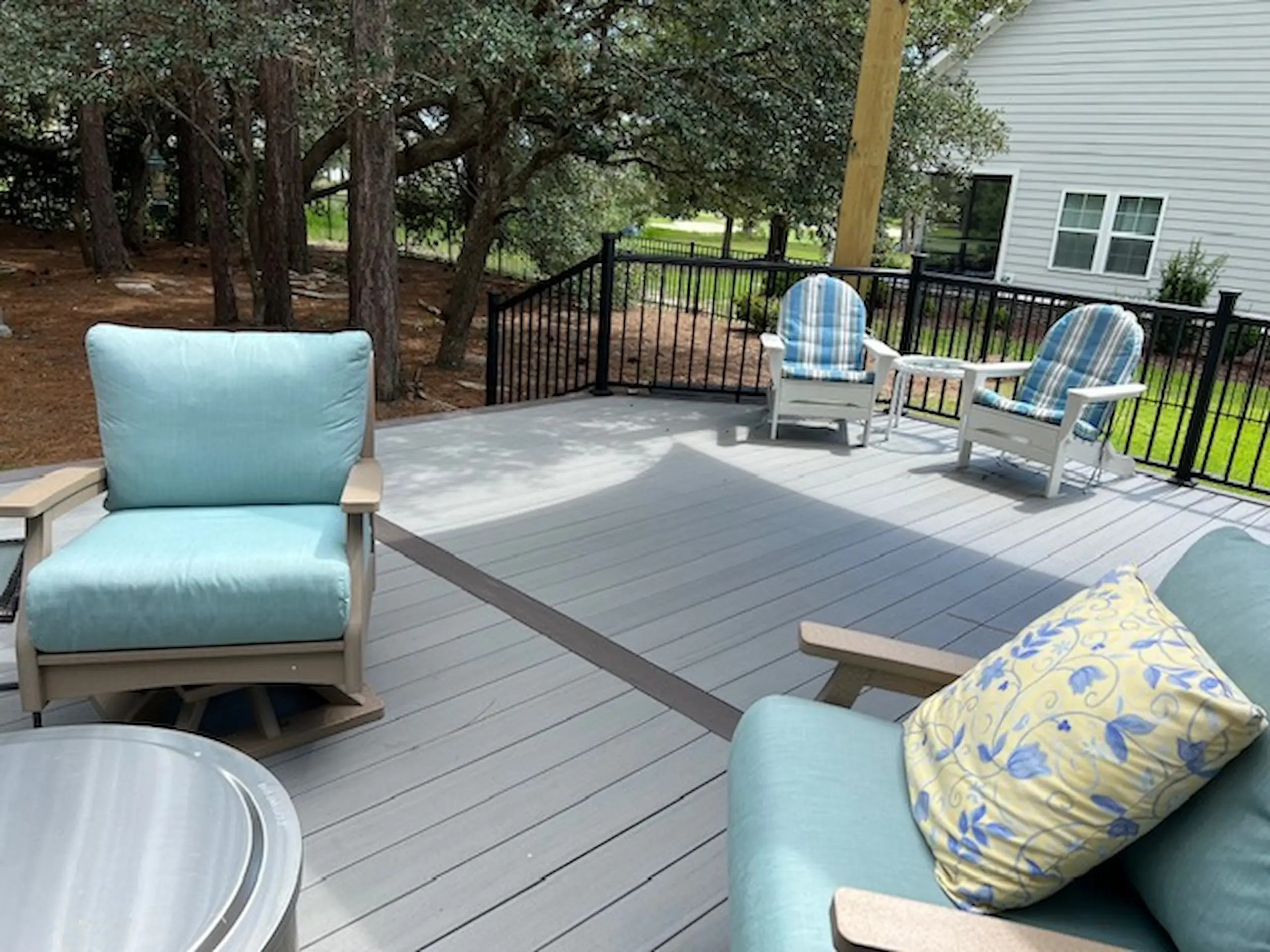 Composite deck with metal railings and outdoor living furniture